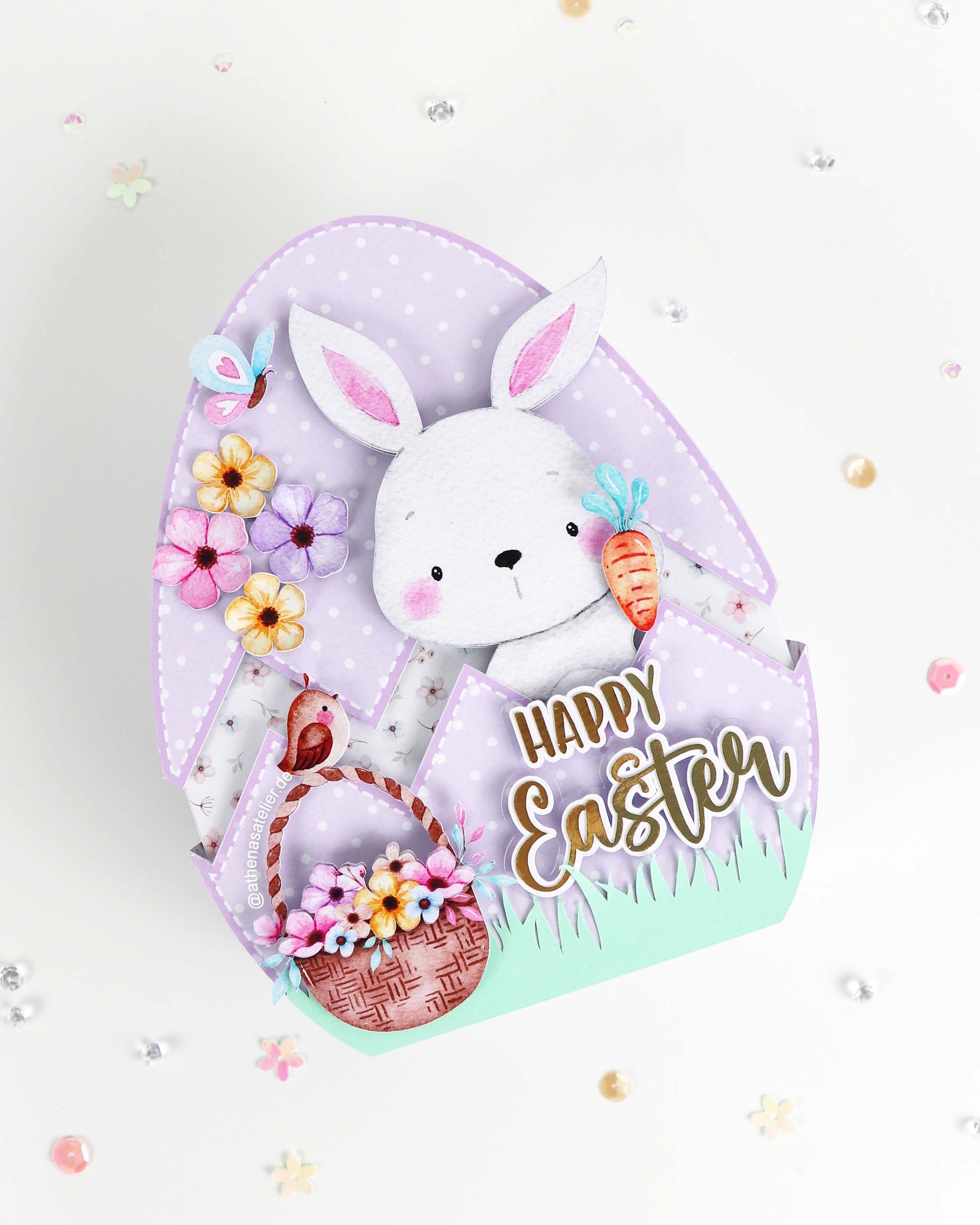 Handgefertigte Oster-Geschenkbox in Eiform aus hochwertigem Motivkarton mit Hasen-Motiv und Aufschrift Frohe Ostern – Athena's Atelier.