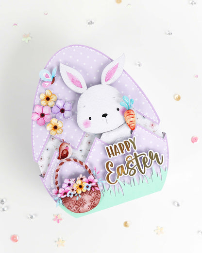 Handgefertigte Oster-Geschenkbox in Eiform aus hochwertigem Motivkarton mit Hasen-Motiv und Aufschrift Frohe Ostern – Athena's Atelier.