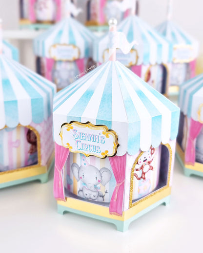 Personalized circus tent carousel spinning centerpiece in light blue and pink with hand-drawn animal illustrations by Athenas Atelier.